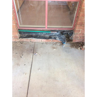 Cleverly rerouting a pipe in the cavity between the bricks and timber frame around a water leak under the slab in Wamboin NSW