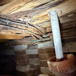 rotten floor timbers caused by a water leak in the walls above